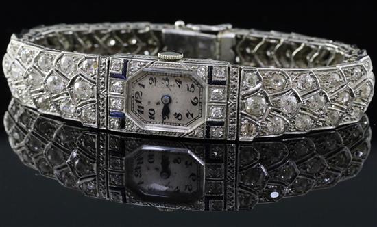 A ladys mid 20th century 18ct white gold, sapphire and diamond set manual wind cocktail watch,
